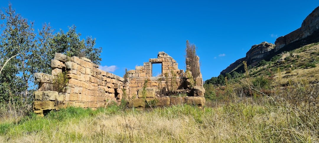 Ancient dry-stone walls of the Great Zimbabwe monument standing against a blue sky