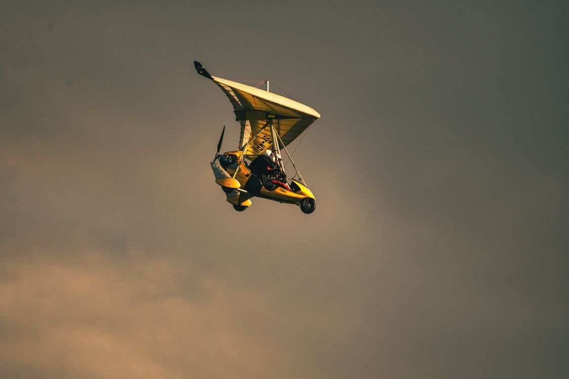 Trike-style microlight aircraft in golden evening light, the type used for Flight of Angels tours at Victoria Falls