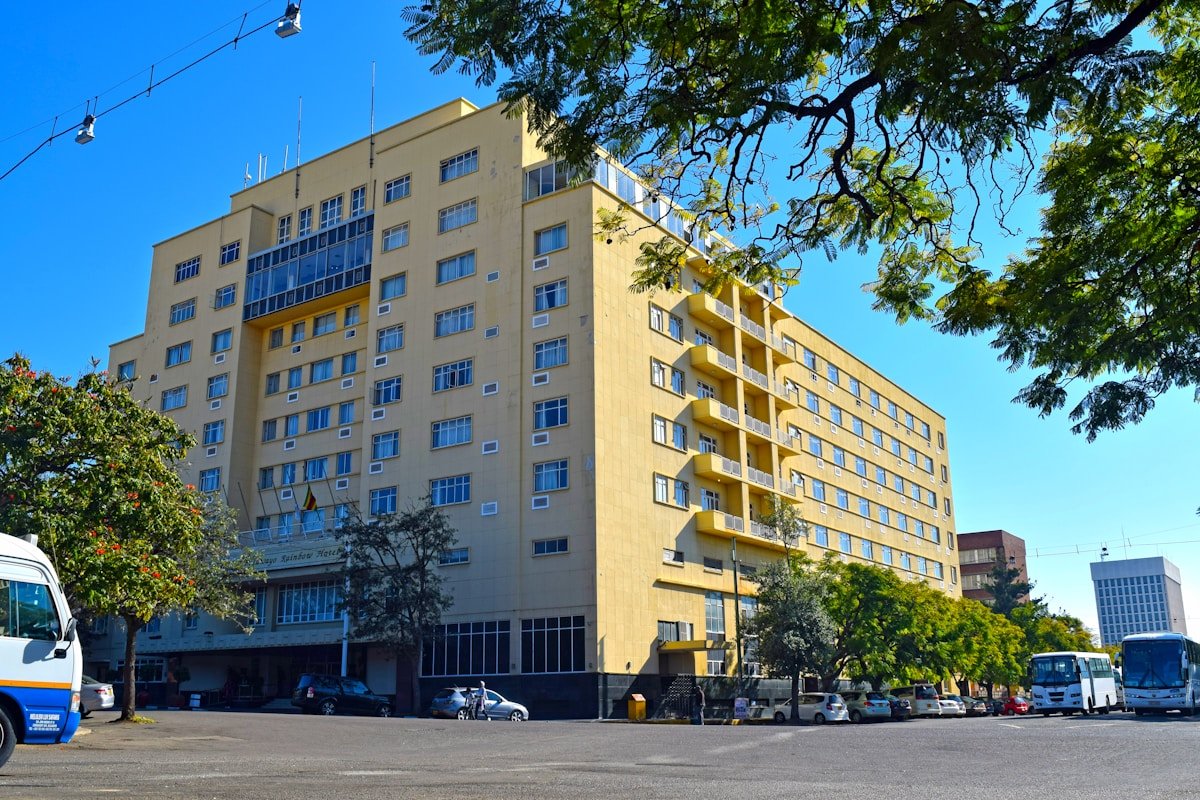 Street scene with a bus parked by a yellow multi-storey building in Bulawayo, Zimbabwe