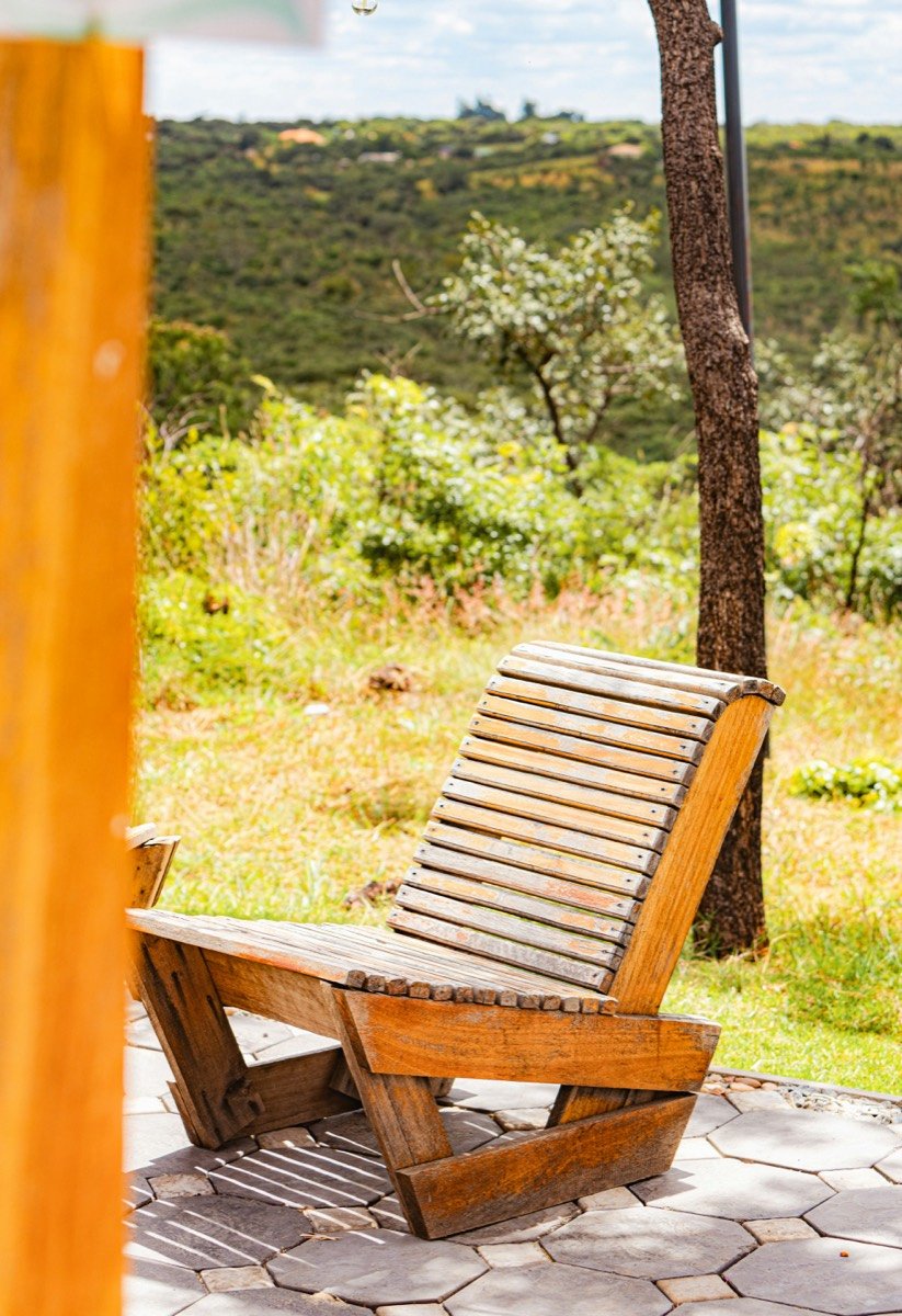 A wooden chair sits outside with a scenic view, Zimbabwe