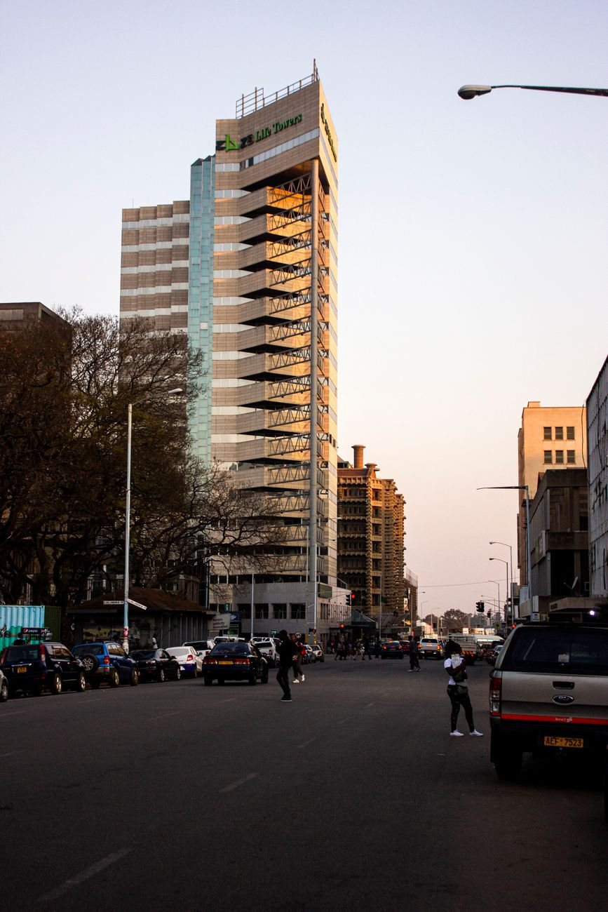 Downtown Harare street scene at dusk with cars and modern buildings, Zimbabwe