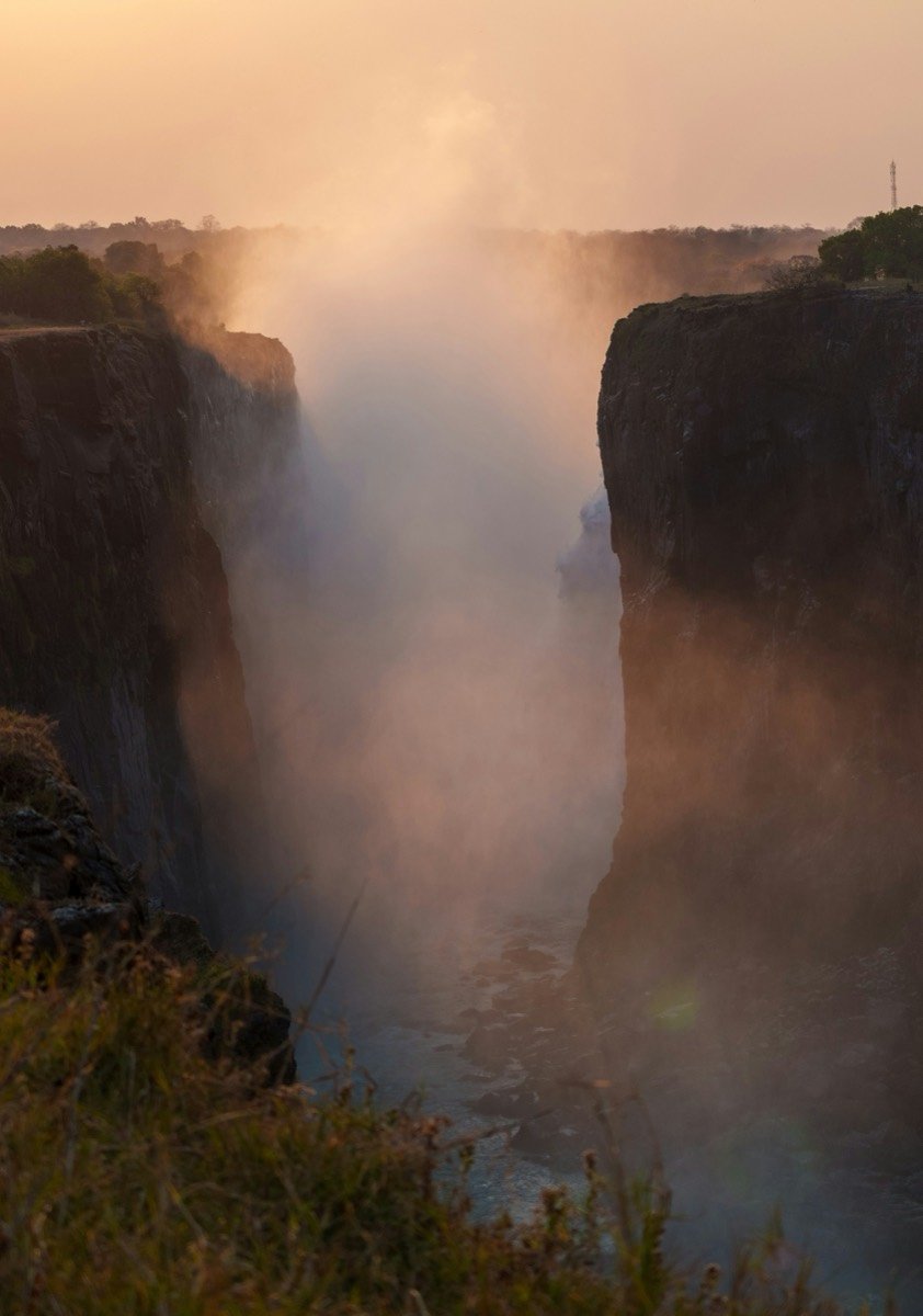 Misty waterfall gorge at sunrise, Victoria Falls, Zimbabwe
