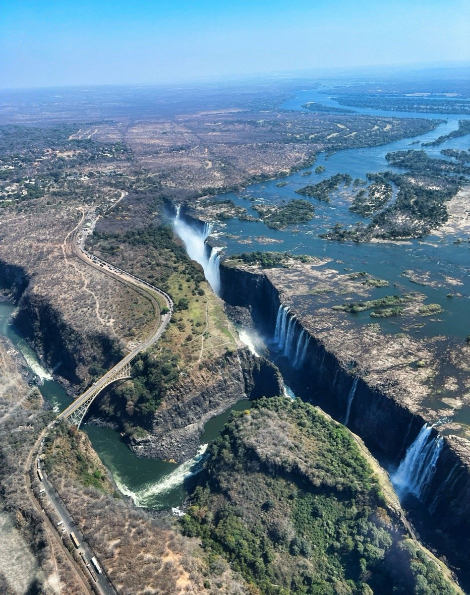 Aerial view of Victoria Falls waterfall with mist rising over the Zambezi gorge, Zimbabwe