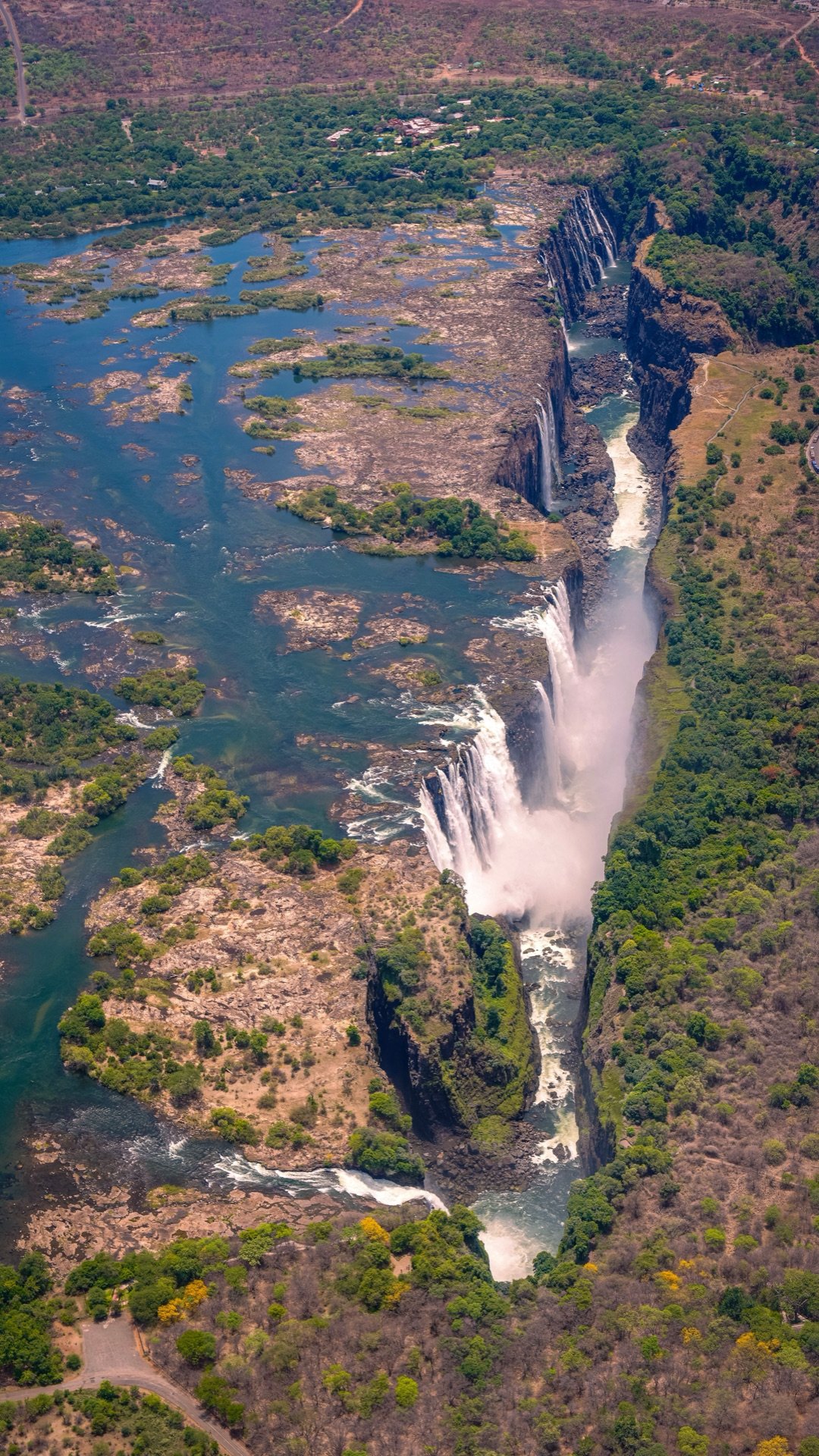 Aerial view of Victoria Falls cascading into the Batoka Gorge, showing both Zimbabwe and Zambia sides
