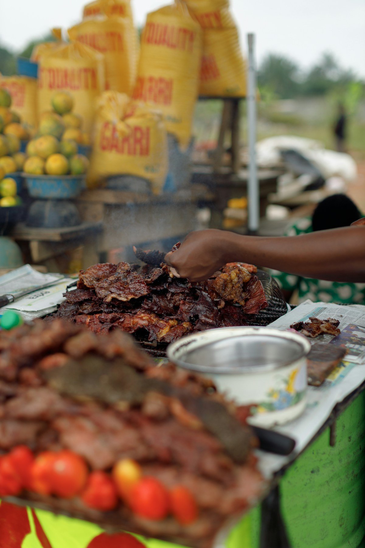 Grilled meat being served at an outdoor street food stall in Africa