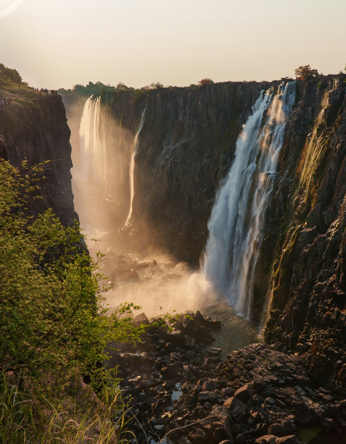 Victoria Falls cascading over basalt cliffs at sunset, Zimbabwe