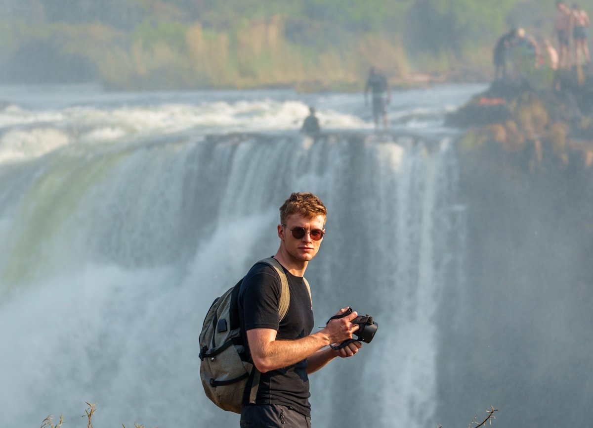 A traveller with camera and backpack near Victoria Falls, Zimbabwe