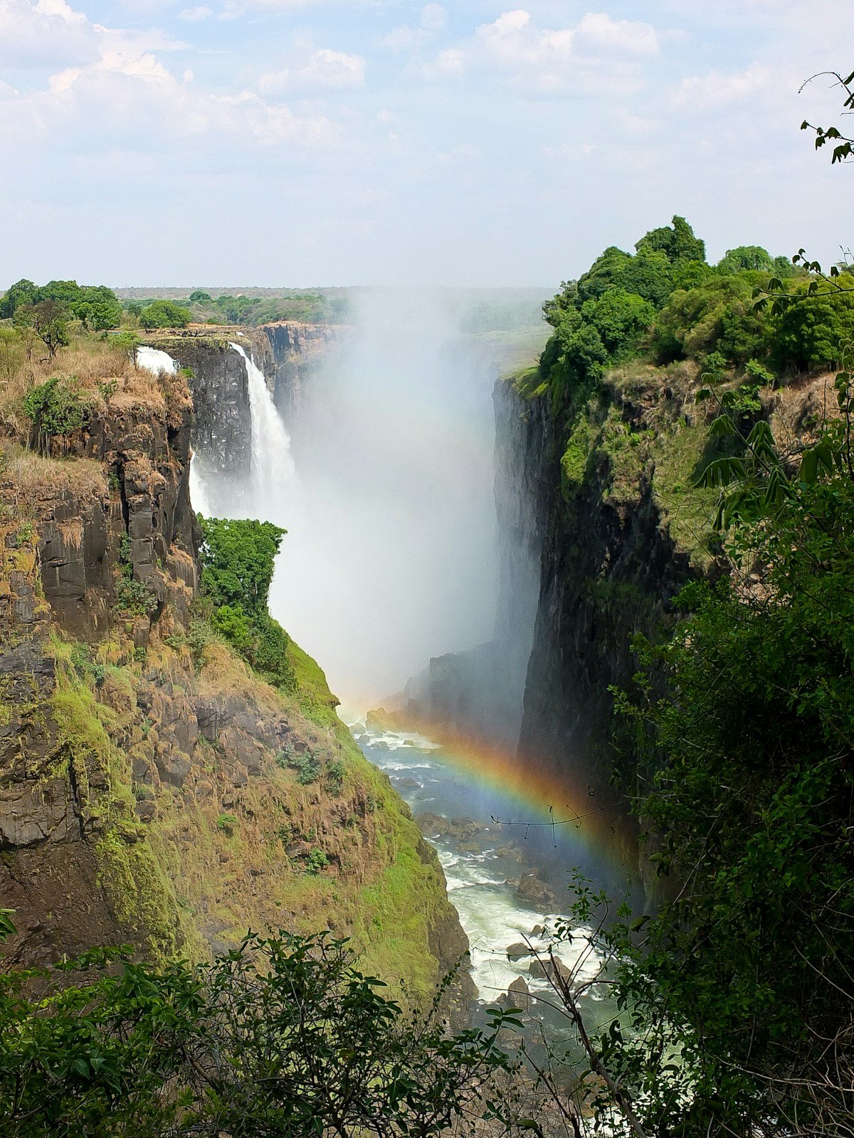 A rainbow arcing over Victoria Falls, Zimbabwe