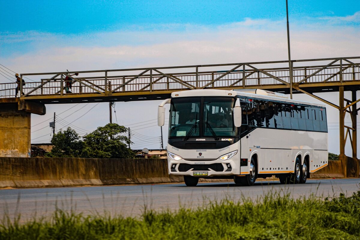 Modern intercity coach bus travelling on a highway in southern Africa